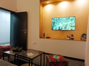 a living room with a table and a window at Apartman City Peace Sarajevo, 72 m2, free parking in Sarajevo