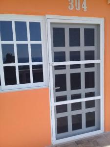 a pair of doors on the side of a house at Hotel Punta del Sol in Zipolite