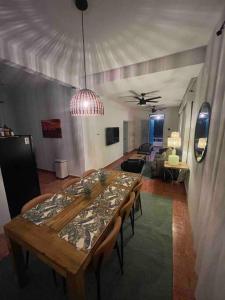 a dining room with a table and a living room at Casa Escaleras in Rincon