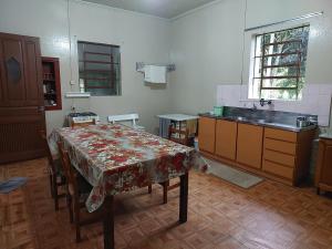 a kitchen with a table and a sink in it at Colônia da Nona Angélica in Farroupilha