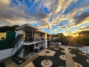 a building with a sunset in the background at Monteverde Numu in Monteverde Costa Rica