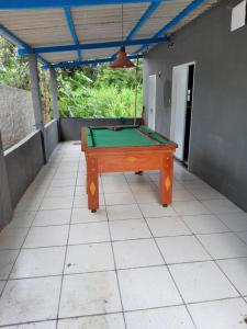 a pool table sitting on top of a patio at Cantinho do sossego in Macaé