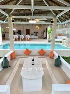 a pool with a white table in front of a pool at Oh'lala luxury pool villas in Thongsala
