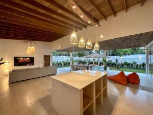 a living room with a couch and a table at Oh'lala luxury pool villas in Thongsala