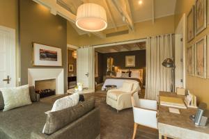 a living room with a couch and a bed at Rosewood Matakauri in Queenstown
