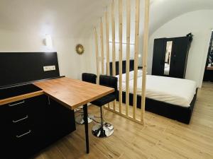 a room with a desk and a bed and a desk and chair at La Petite Suite in Sanremo