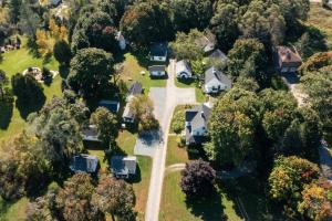 an aerial view of a house with trees at Bar Harbor Cottages & Suites in Bar Harbor