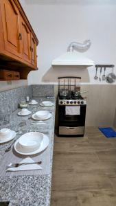 uma cozinha com um balcão com placas e um fogão em Beautiful room near everything 2 em Cuenca