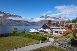 a house with a view of a lake and mountains at Rosewood Matakauri in Queenstown