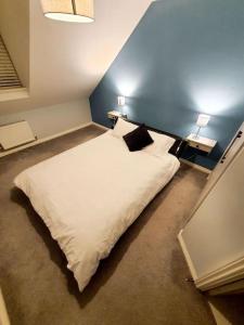 a bedroom with a white bed with two pillows at - Modern 3 Bed in Newport - Close to City Centre - in Newport