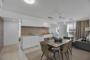 a kitchen and dining room with a table and chairs at Dual Key Three Bedroom Apartment close to CBD in Mackay