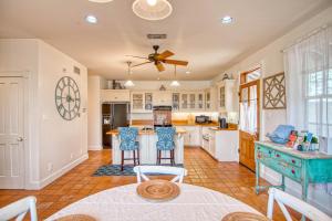 a kitchen with white cabinets and a table and chairs at Gardens of Baron's Creek - Unit D in Fredericksburg