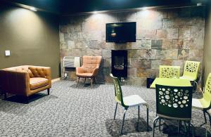a waiting room with chairs and a fireplace at Americas Best Value Inn Wall in Wall