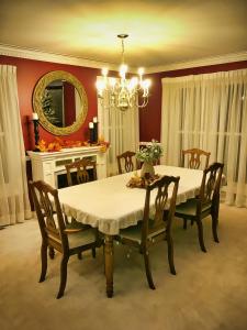 a dining room with a table and chairs and a mirror at North Oaks Estate in Blaine