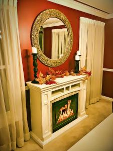 a living room with a fireplace and a mirror at North Oaks Estate in Blaine