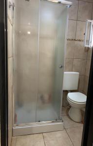 a shower in a bathroom with a toilet at Casa Monte hermoso a media cuadra Del Mar in Monte Hermoso +5 photos
