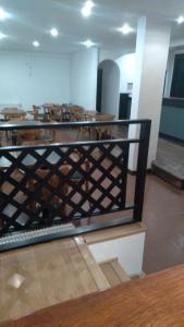 a room with a fence with tables and chairs at 3Reyes in Necochea