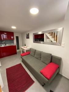 a living room with a gray couch with red pillows at Charm of Lisbon II in Lisbon