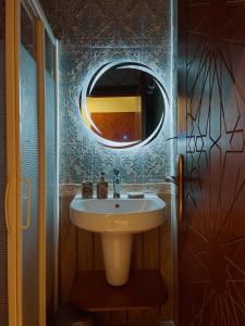 a bathroom with a sink and a mirror at Sphinx golden gate pyramids view in Cairo