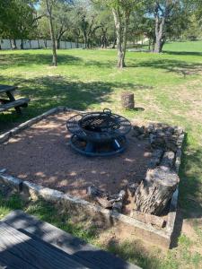 a fire pit in the middle of a park at The Rock House Hideaway - TANK HOUSE in Fredericksburg