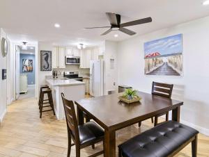 a kitchen and dining room with a table and chairs at Brooks Beach Vacations Bungalow B116 Oceanside in Oceanside