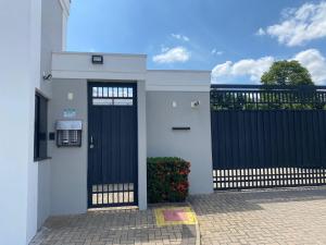 une maison avec un portail noir et une clôture dans l'établissement Apartamento próximo ao Pão de Açúcar e centro, à Limeira