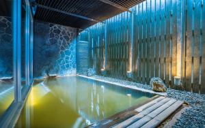 a large pool of water in a building with aitating at The Vale Niseko in Kutchan +51 photos