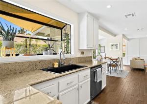 a kitchen with a sink and a large window at 3BR Desert Oasis: King Bd W/POOL in Las Vegas