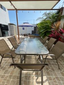 een tafel en stoelen op een patio met uitzicht op het strand bij Departamento exclusivo en salinas in Salinas