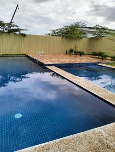 a swimming pool with blue water in a backyard at Plumera Homes in Lapu Lapu City