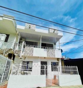 a white house with balconies on the side of it at Apartamento en zona de Torices in Cartagena de Indias