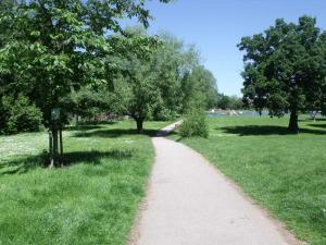 a path in a park with trees and grass at Warm Home in Birmingham's Peaceful Green Oasis in Frankley