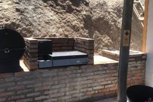 a brick oven sitting on top of a brick wall at Refugio cordillerano, quincho y piscina in San Francisco