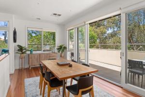 a kitchen and dining room with a table and chairs at Boutique Stays - Flora in Hampaton