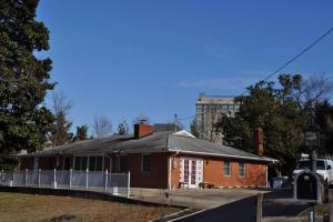 a red brick house with a fence around it at Harbor Riverside Property in Fort Washington