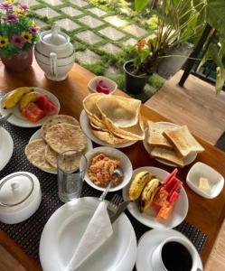 a table with plates of food on a table at Nature's Glow Home Stay AND RESTAURANT in Ella