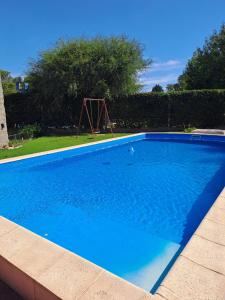 a small blue swimming pool with a swing at Casa Belén in Toay