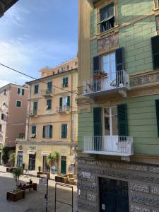 a yellow building with white windows and balconies on a street at CASA BASTIO in La Spezia