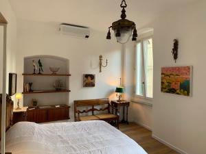 a bedroom with a bed and a desk and a window at CASA BASTIO in La Spezia