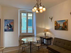 a living room with a table and chairs and a couch at CASA BASTIO in La Spezia