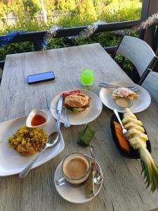 a wooden table with plates of food on it at Resting Place Ko Yao Yai in Ko Yao Yai