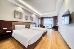 Katil atau katil-katil dalam bilik di Yiwu International Mansion
