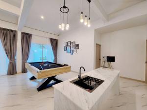 a large room with a pool table in it at Niyham Pool Villa in Bang Phli