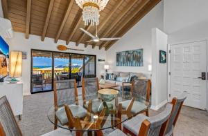 a dining room with a glass table and chairs at Luxurious & Spacious Ocean Vistas in Wailea