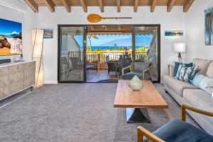 a living room with a couch and a table at Luxurious & Spacious Ocean Vistas in Wailea