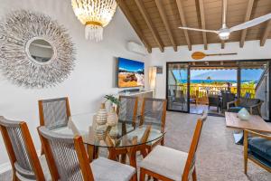 a dining room with a glass table and chairs at Luxurious & Spacious Ocean Vistas in Wailea