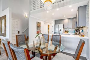 a dining room and kitchen with a glass table and chairs at Luxurious & Spacious Ocean Vistas in Wailea