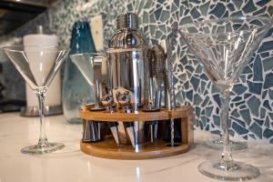 a bottle and two glasses sitting on a table at Luxurious & Spacious Ocean Vistas in Wailea