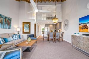 a living room with a couch and a table at Luxurious & Spacious Ocean Vistas in Wailea
