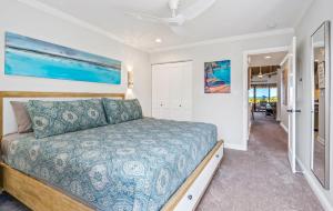 a bedroom with a large bed and a hallway at Luxurious & Spacious Ocean Vistas in Wailea +32 photos